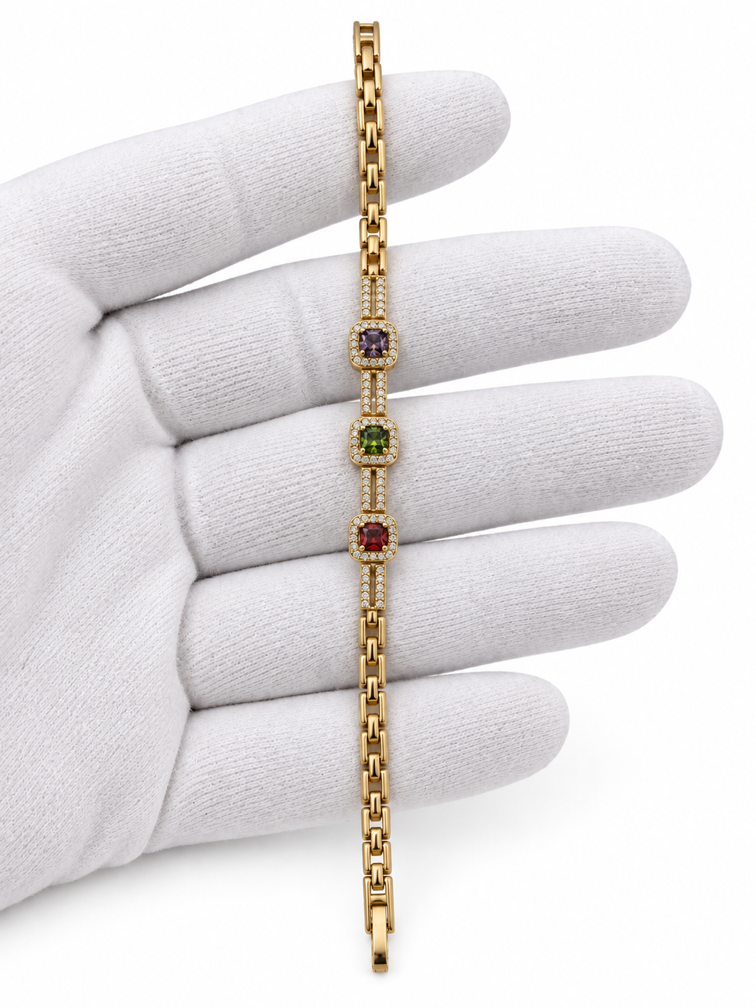 Gold-tone bracelet with three square purple, green and red decorative accents framed by clear-looking stones, double-row chain detailing and a clasp closure.