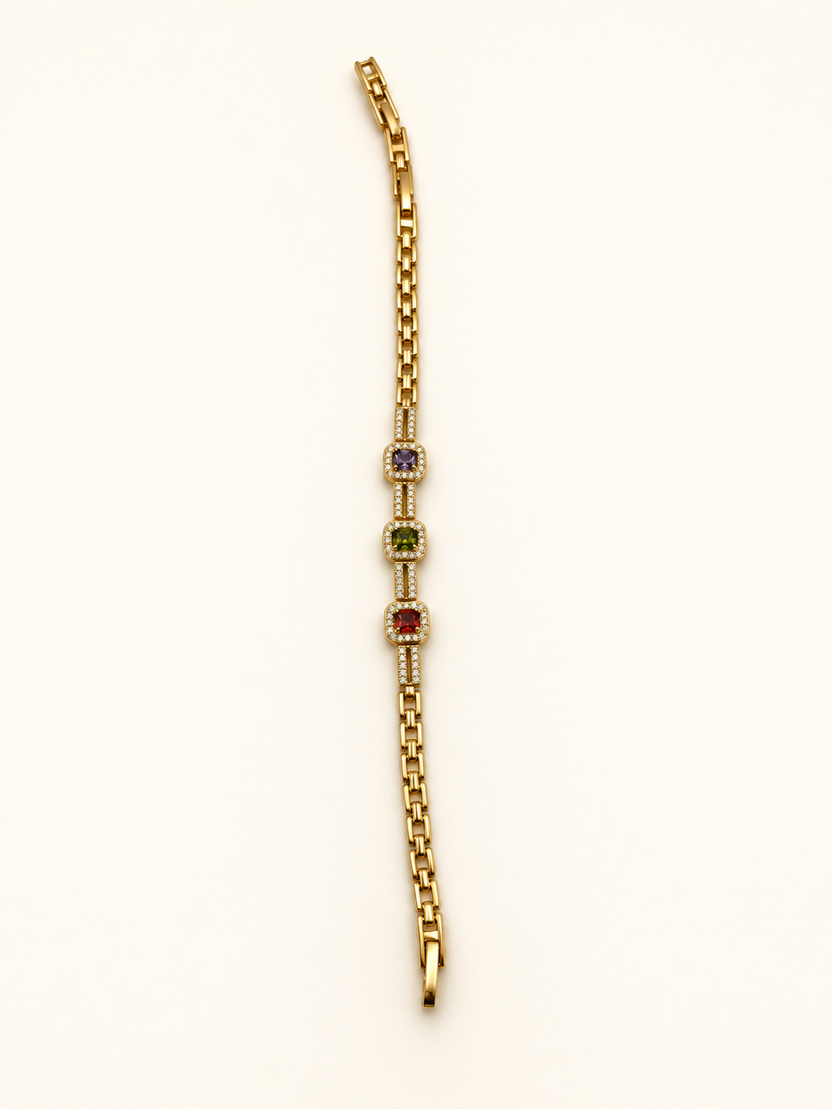 Gold-tone bracelet with three square purple, green and red decorative accents framed by clear-looking stones, double-row chain detailing and a clasp closure.
