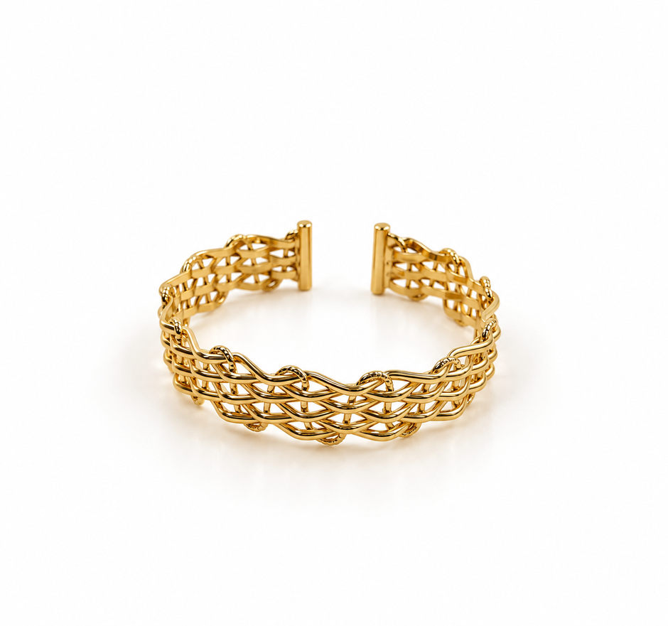 Golden open cuff bracelet featuring an intricate criss-cross lattice band and a rectangular central panel decorated with clear sparkling stones, displayed from the front and back.