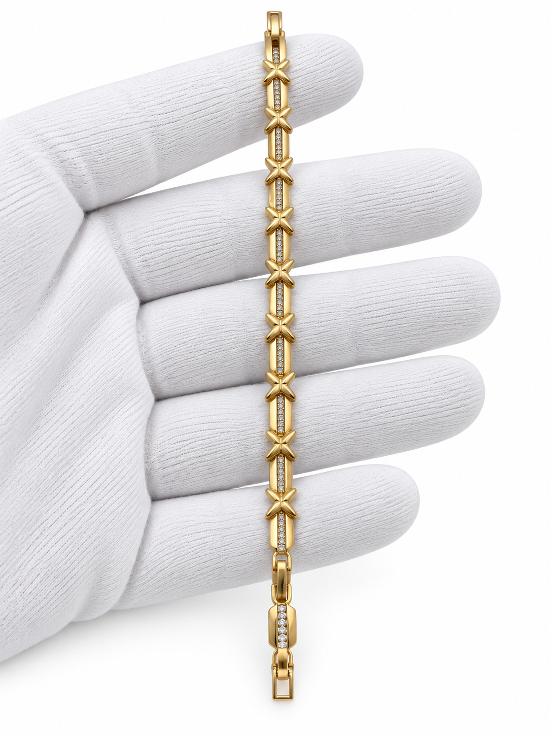 Gold-tone bracelet with blue, pink, green and clear square-shaped accents, decorative links, a lobster-style clasp and an extension chain, held against a white background.