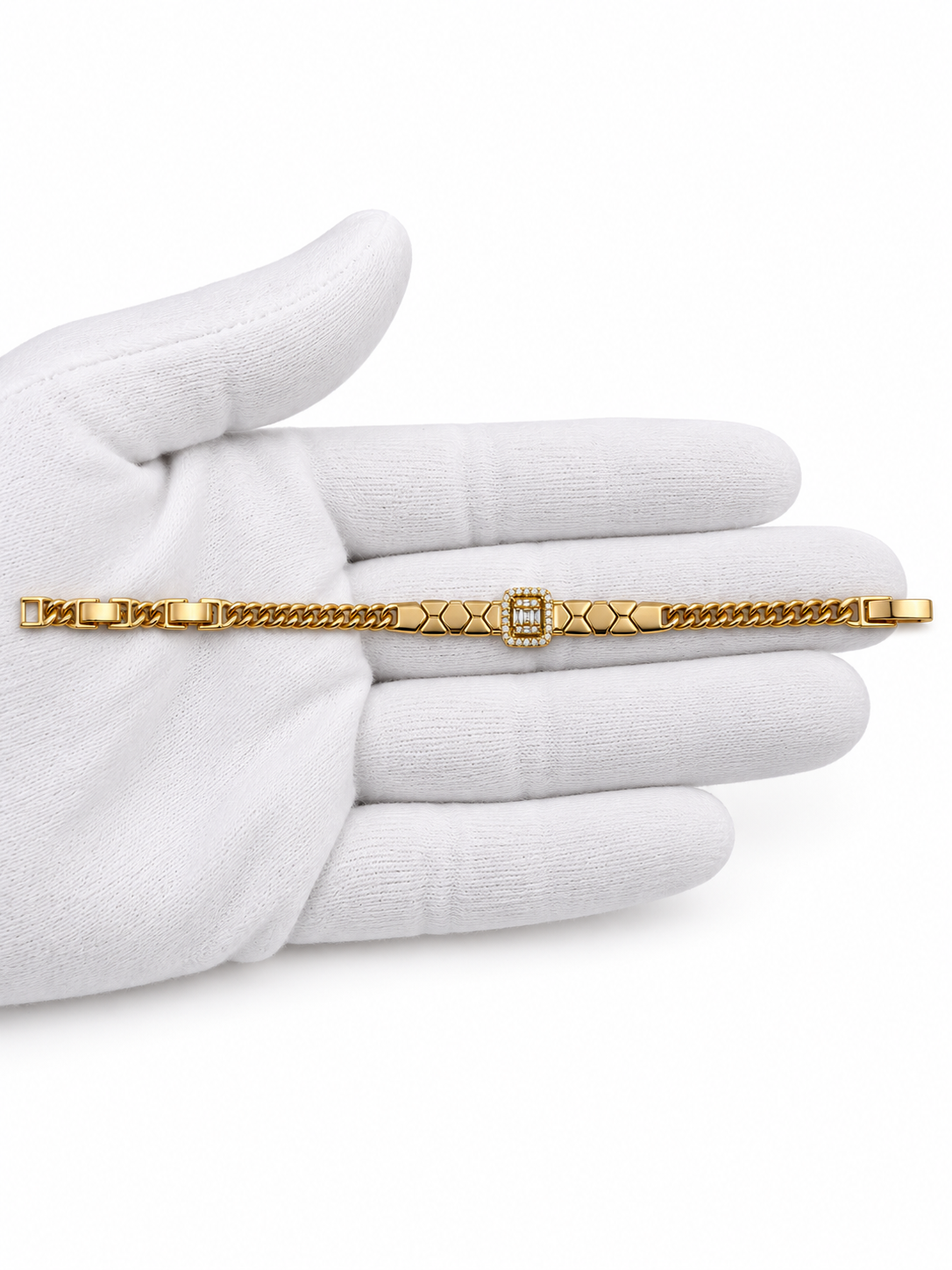 Gold-tone bracelet featuring angular geometric links, a rectangular central embellishment bordered with clear reflective stones, and fine interlocking chain ends.