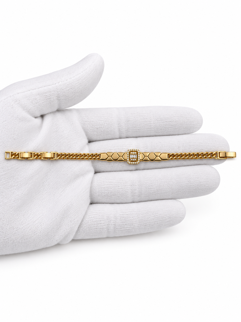 Gold-tone bracelet featuring angular geometric links, a rectangular central embellishment bordered with clear reflective stones, and fine interlocking chain ends.