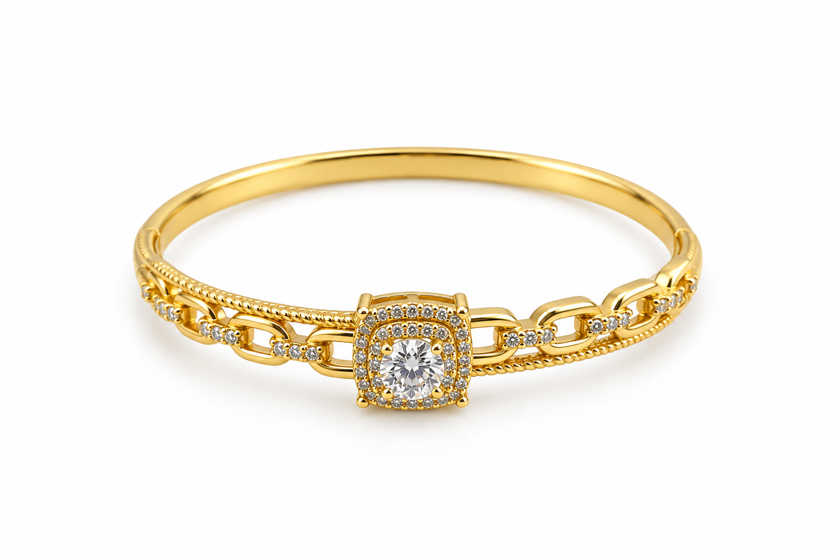 Gold-tone bracelet with a square-shaped central motif, large clear faceted centrepiece, surrounding rows of small clear decorative stones and an intricate openwork linked band.