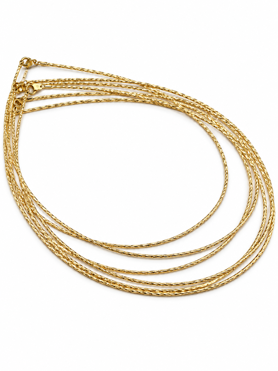 Delicate gold-tone chain necklace with closely linked textured detailing, displayed in multiple loops on a white background and worn around the neck on a black jewellery bust.