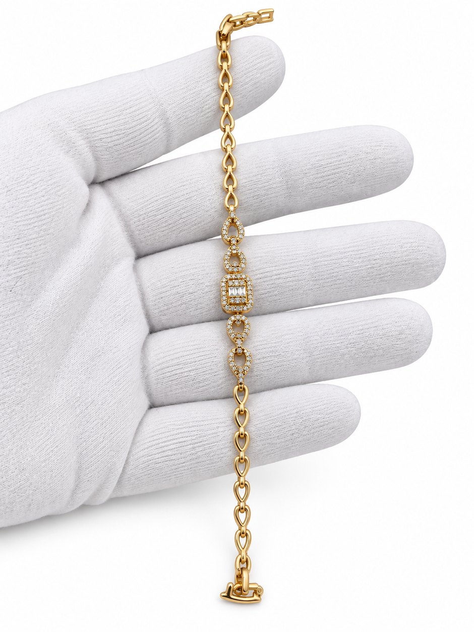 Gold-tone bracelet with three square purple, green and red decorative accents framed by clear-looking stones, double-row chain detailing and a clasp closure.