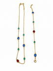 Gold-tone necklace and matching bracelet featuring delicate chains with spaced blue, teal green and burgundy red decorative accents, displayed on a model and separately.