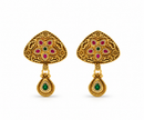Gold-tone floral temple necklace set displayed on white jewellery stands, featuring a triangular ornamental pendant with green and magenta-pink accents, a beaded chain, and matching earrings with green teardrop-shaped drops.