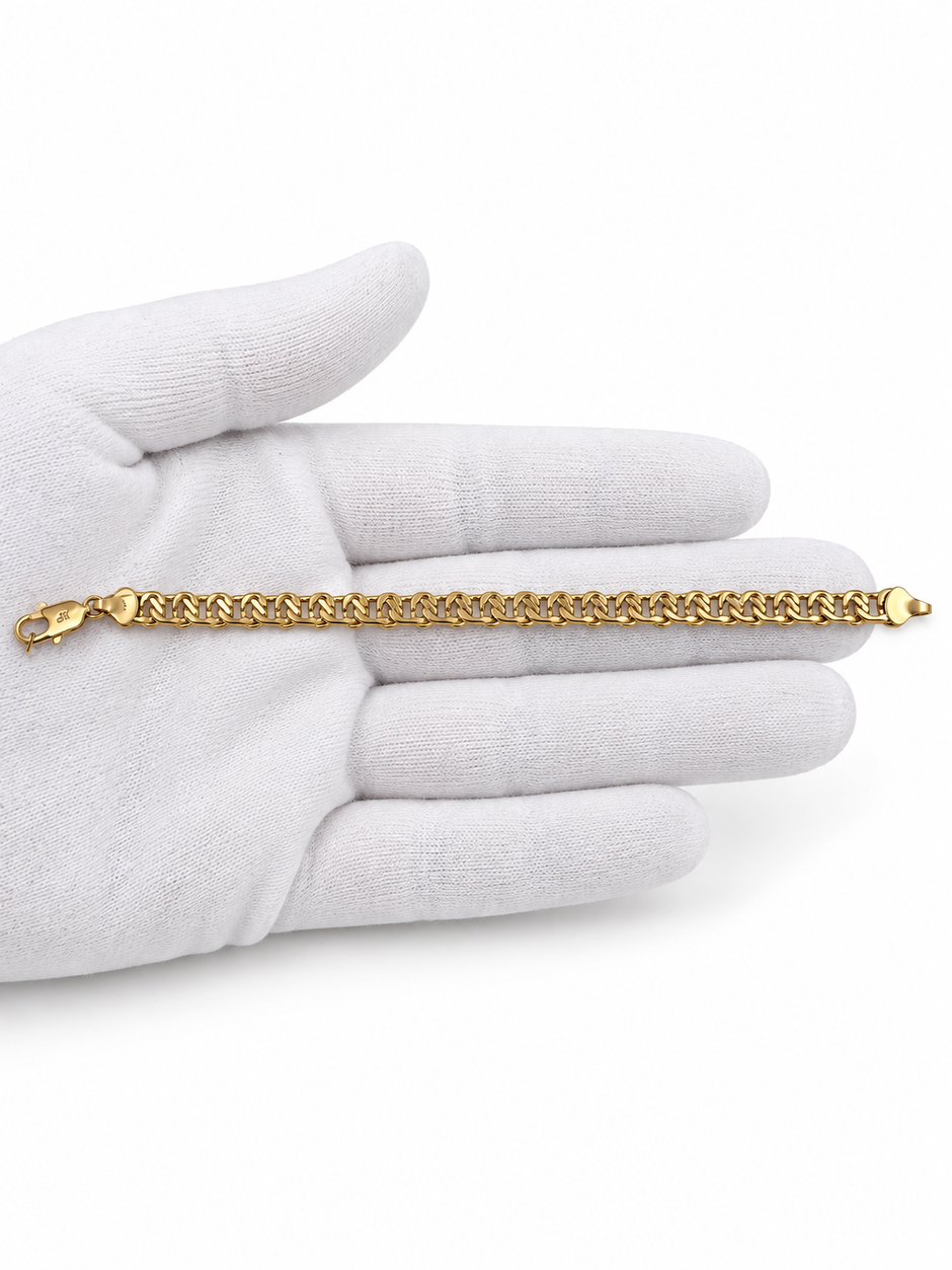 Gold-tone bracelet featuring a continuous chain of rounded interlocking links with a twisted appearance, shown separately and worn around a woman's wrist.
