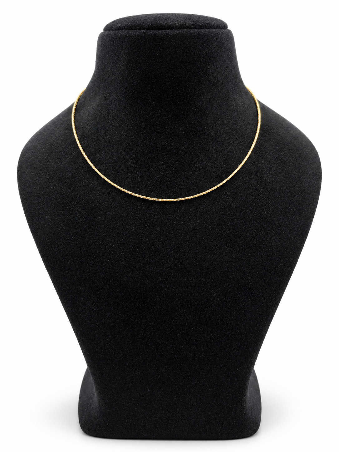 Delicate gold-tone chain necklace with closely linked textured detailing, displayed in multiple loops on a white background and worn around the neck on a black jewellery bust.