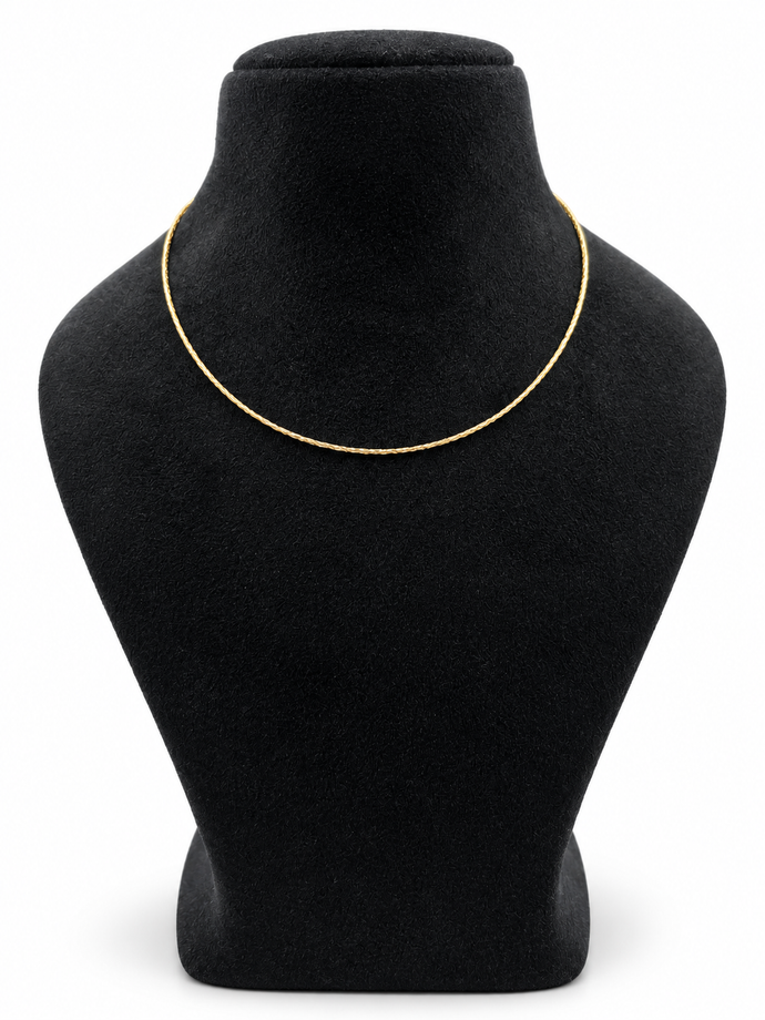 Delicate gold-tone chain necklace with closely linked textured detailing, displayed in multiple loops on a white background and worn around the neck on a black jewellery bust.