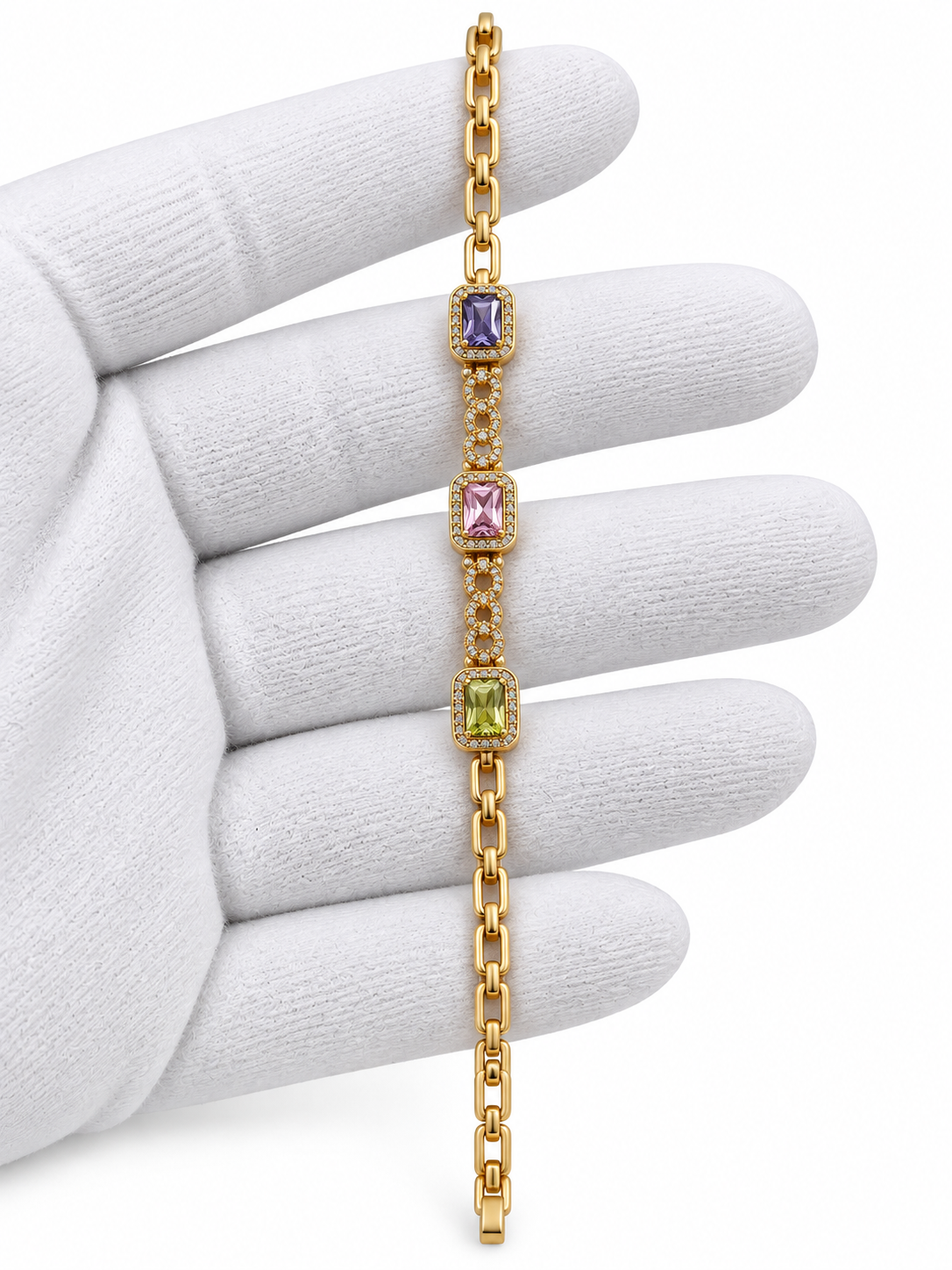 Gold-tone link bracelet with three rectangular purple, pink and green stones in square clear-stone settings, shown from the front and reverse.
