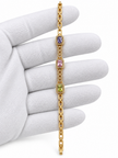 Gold-tone link bracelet with three rectangular purple, pink and green stones in square clear-stone settings, shown from the front and reverse.
