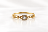 Gold-tone bracelet with a square-shaped central motif, large clear faceted centrepiece, surrounding rows of small clear decorative stones and an intricate openwork linked band.