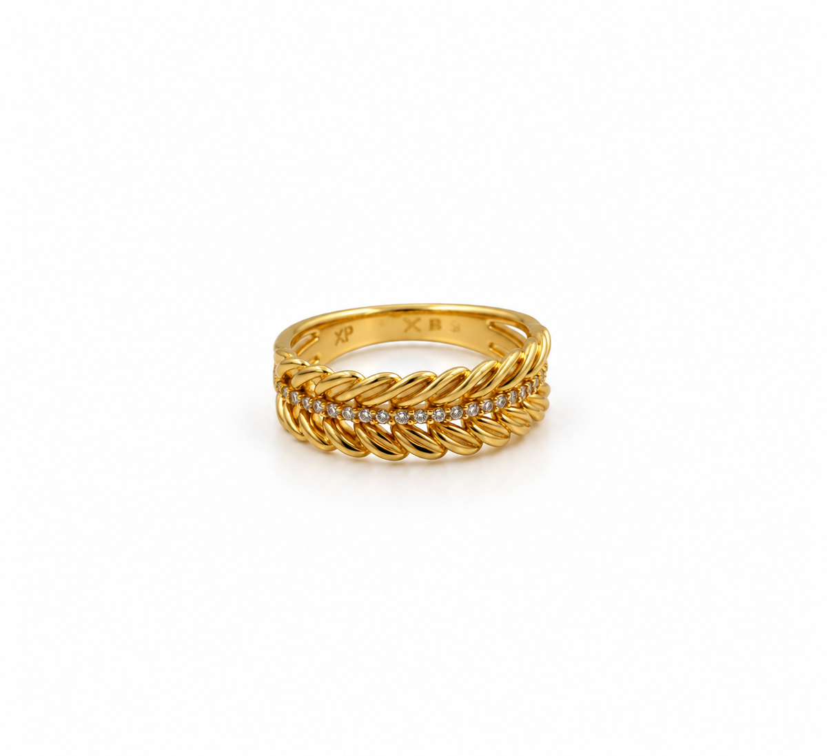Gold-tone decorative ring with overlapping diagonal leaf-like curves and a central row of small clear stones, shown on a white background and worn on a finger.