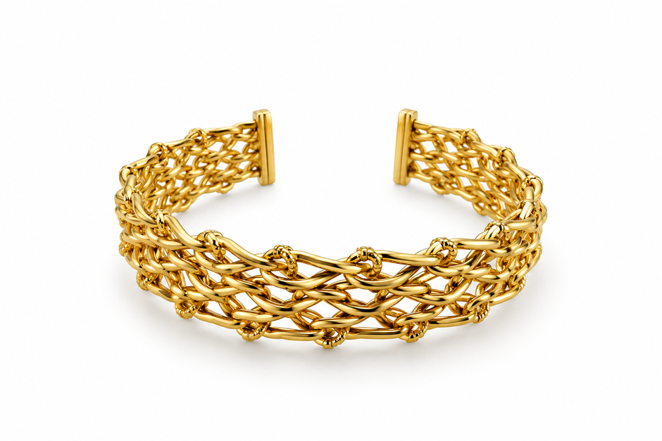 Golden open cuff bracelet featuring an intricate criss-cross lattice band and a rectangular central panel decorated with clear sparkling stones, displayed from the front and back.