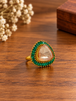 Bhavmayi gold-tone statement ring with green rectangular stones surrounding a large rounded triangular centre