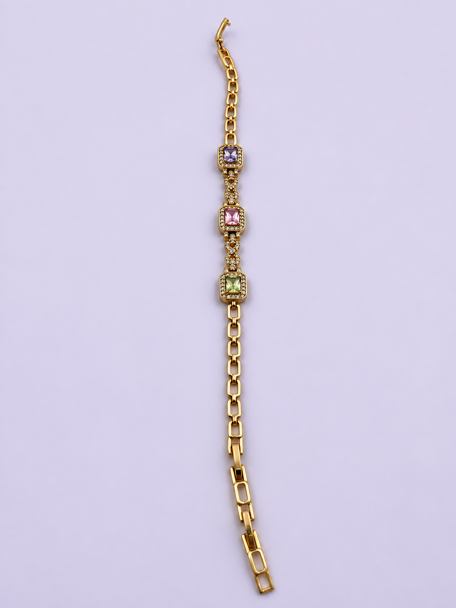 Gold-tone link bracelet with three rectangular purple, pink and green stones in square clear-stone settings, shown from the front and reverse.