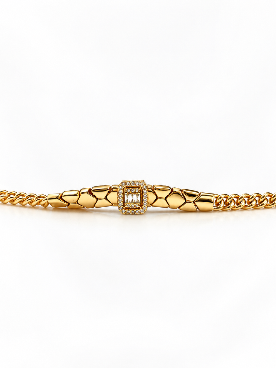 Gold-tone bracelet featuring angular geometric links, a rectangular central embellishment bordered with clear reflective stones, and fine interlocking chain ends.