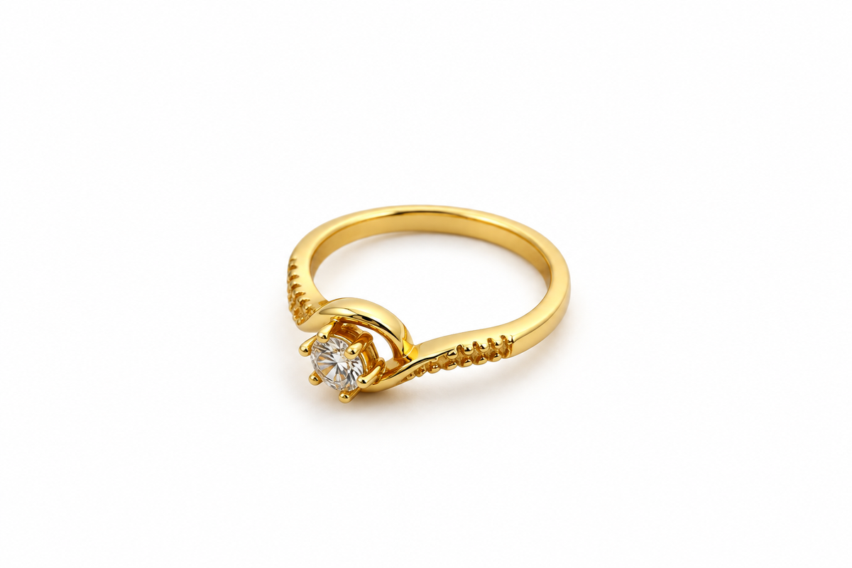 Gold-tone ring with a round floral arrangement of clear stones, curved golden detailing and small clear accents along the band, shown on a white background and worn on a finger.