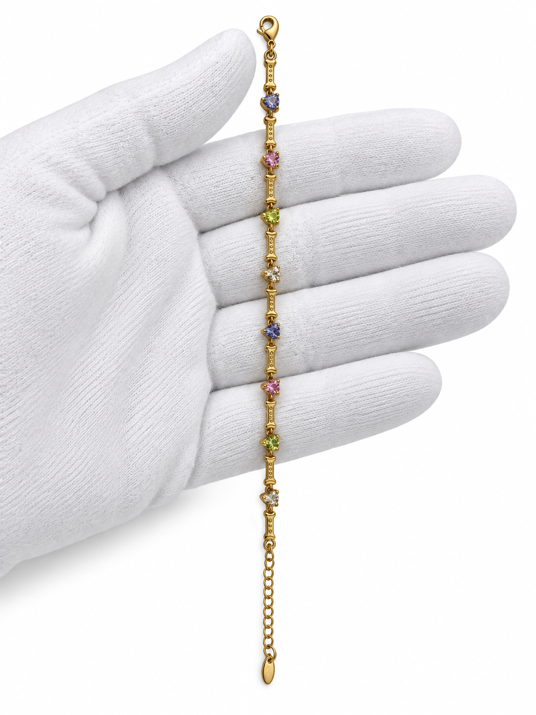 Gold-tone chain bracelet featuring geometric golden links and multicoloured blue, purple, pink, green and clear decorative accents, shown separately and worn on a wrist.