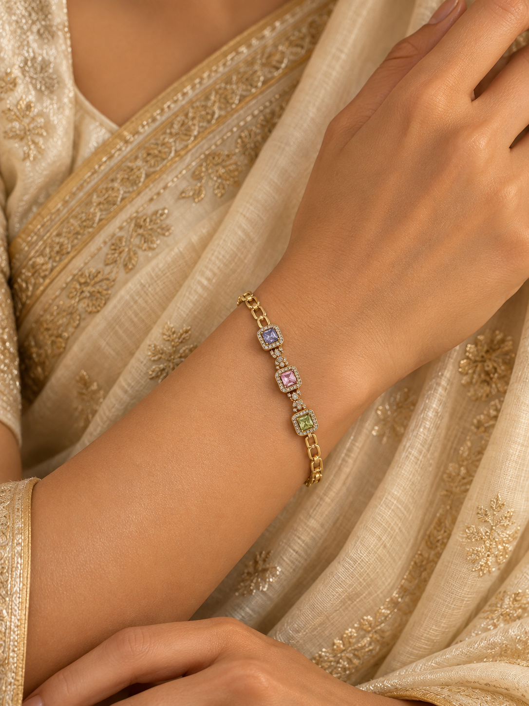 Gold-tone link bracelet with three rectangular purple, pink and green stones in square clear-stone settings, shown from the front and reverse.