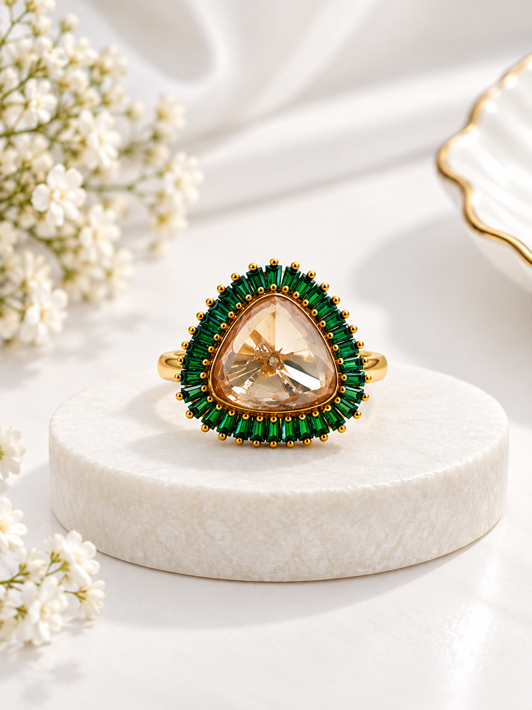Bhavmayi gold-tone statement ring with green rectangular stones surrounding a large rounded triangular centre