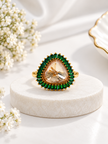 Bhavmayi gold-tone statement ring with green rectangular stones surrounding a large rounded triangular centre