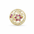A round gold filigree brooch featuring a central floral motif with pinkish-red gemstones and white pearl-like accents, set against a plain white background.