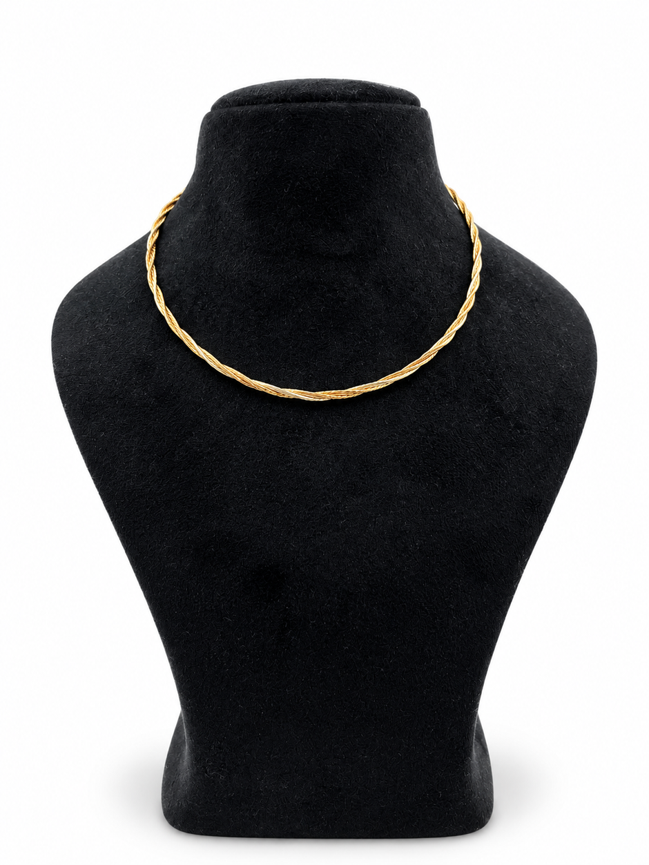 Delicate gold and silver-tone multi-strand chain necklace with an intertwined twisted-link pattern and clasp closure, displayed on a black necklace stand.