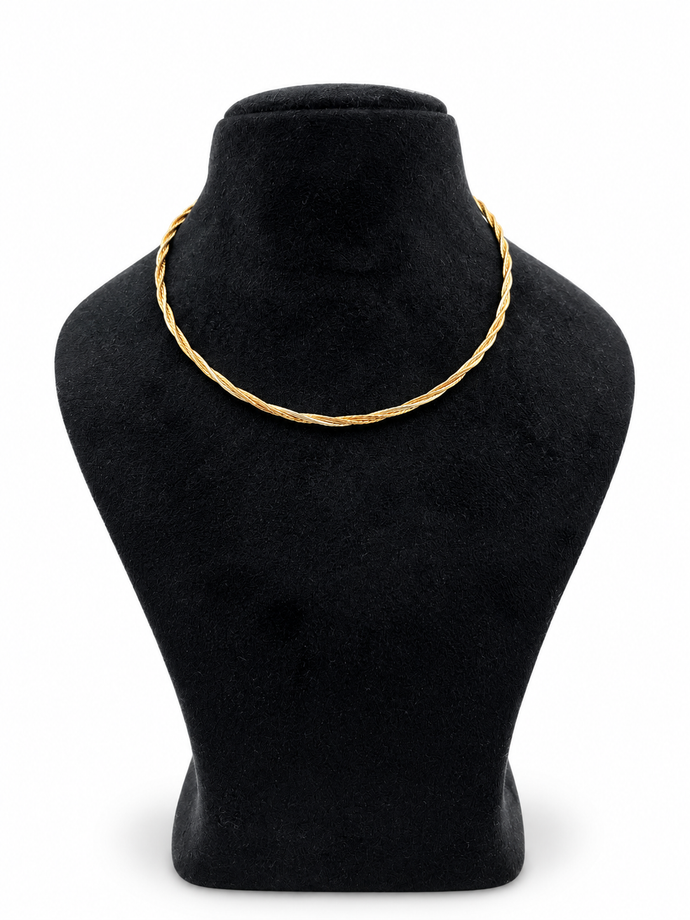 Delicate gold and silver-tone multi-strand chain necklace with an intertwined twisted-link pattern and clasp closure, displayed on a black necklace stand.