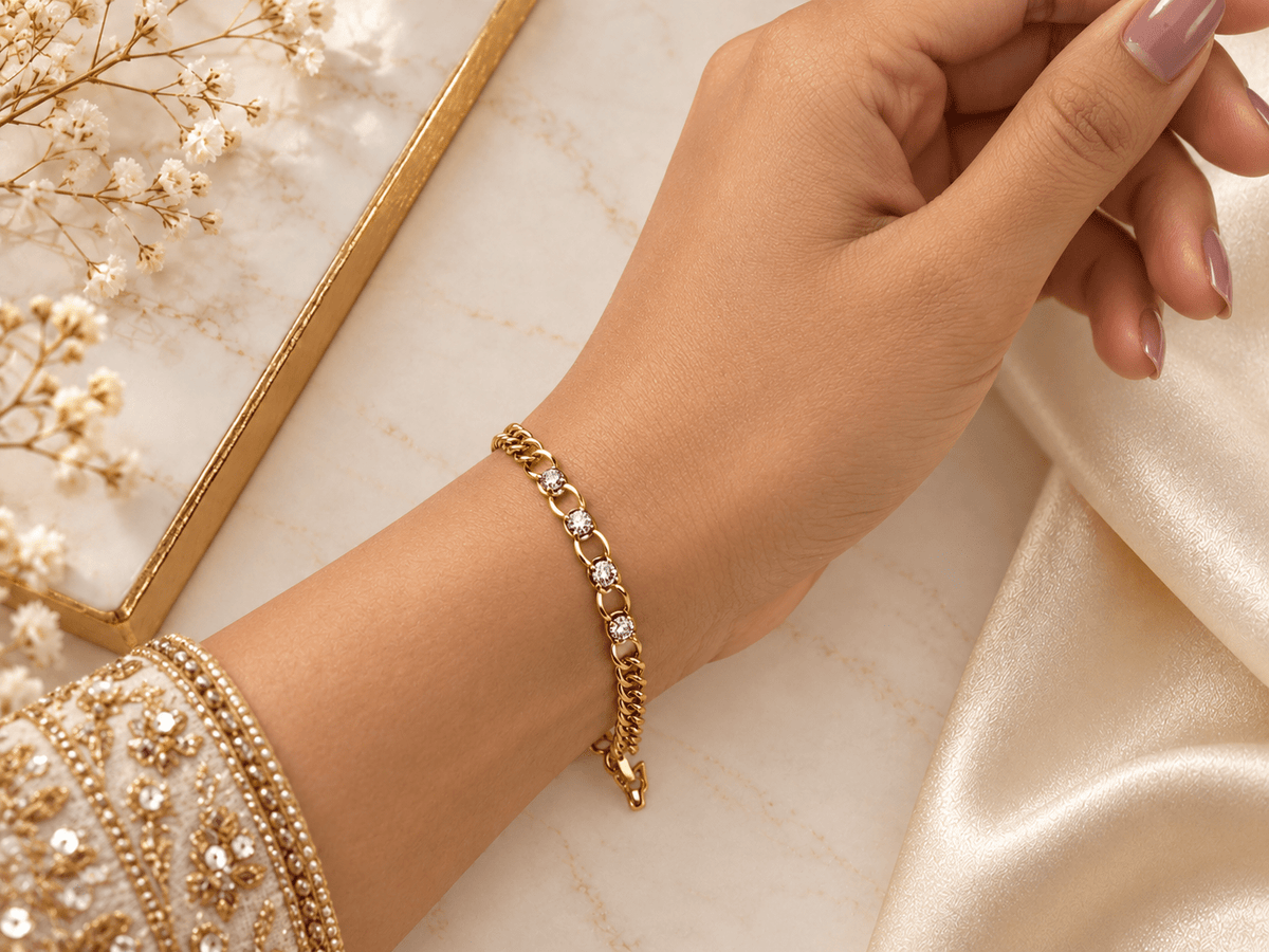 Bhavmayi golden bracelets with varied link designs and clear sparkling stone-like accents shown worn on the wrist