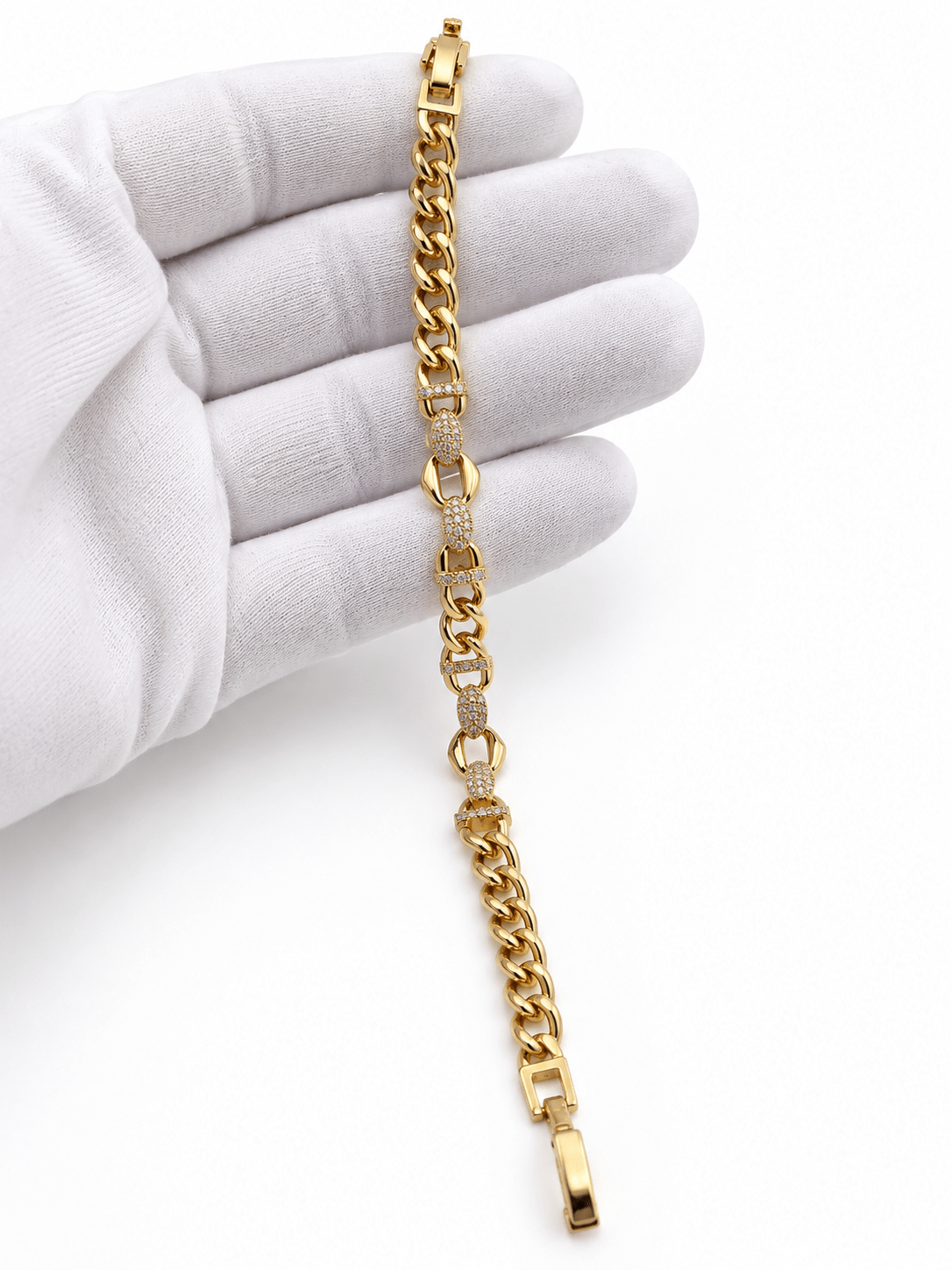 Bhavmayi golden bracelets with varied link designs and clear sparkling stone-like accents shown worn on the wrist