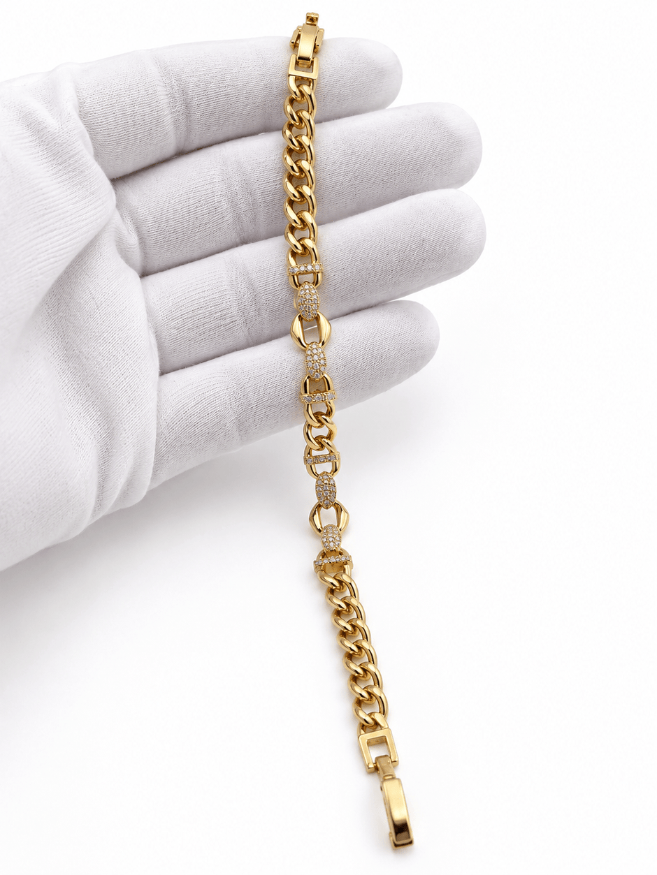Bhavmayi golden bracelets with varied link designs and clear sparkling stone-like accents shown worn on the wrist