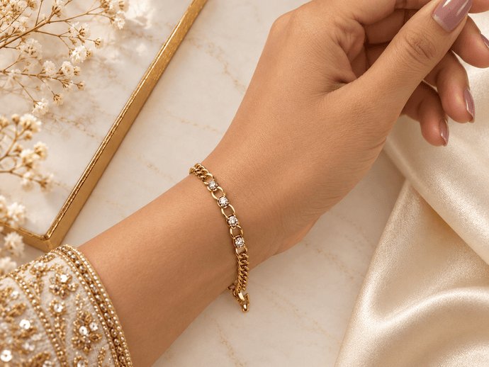 Bhavmayi golden bracelets with varied link designs and clear sparkling stone-like accents shown worn on the wrist