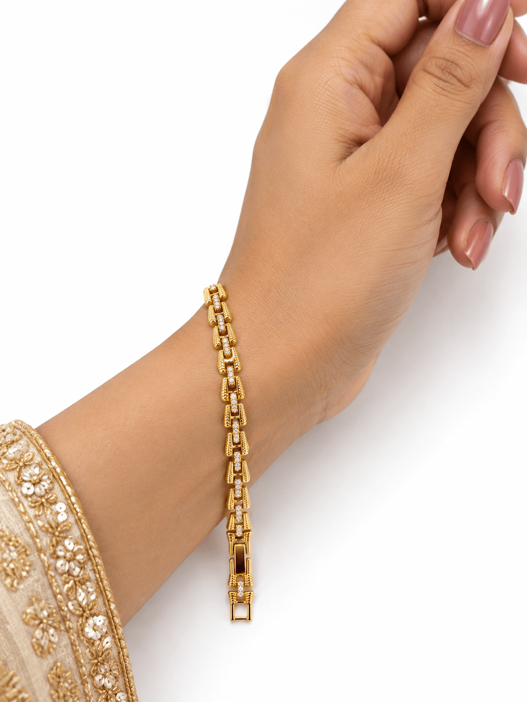 Bhavmayi golden bracelets with varied link designs and clear sparkling stone-like accents shown worn on the wrist