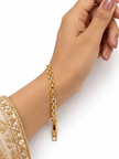 Bhavmayi golden bracelets with varied link designs and clear sparkling stone-like accents shown worn on the wrist