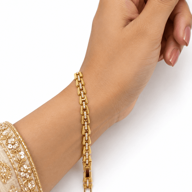 Bhavmayi golden bracelets with varied link designs and clear sparkling stone-like accents shown worn on the wrist