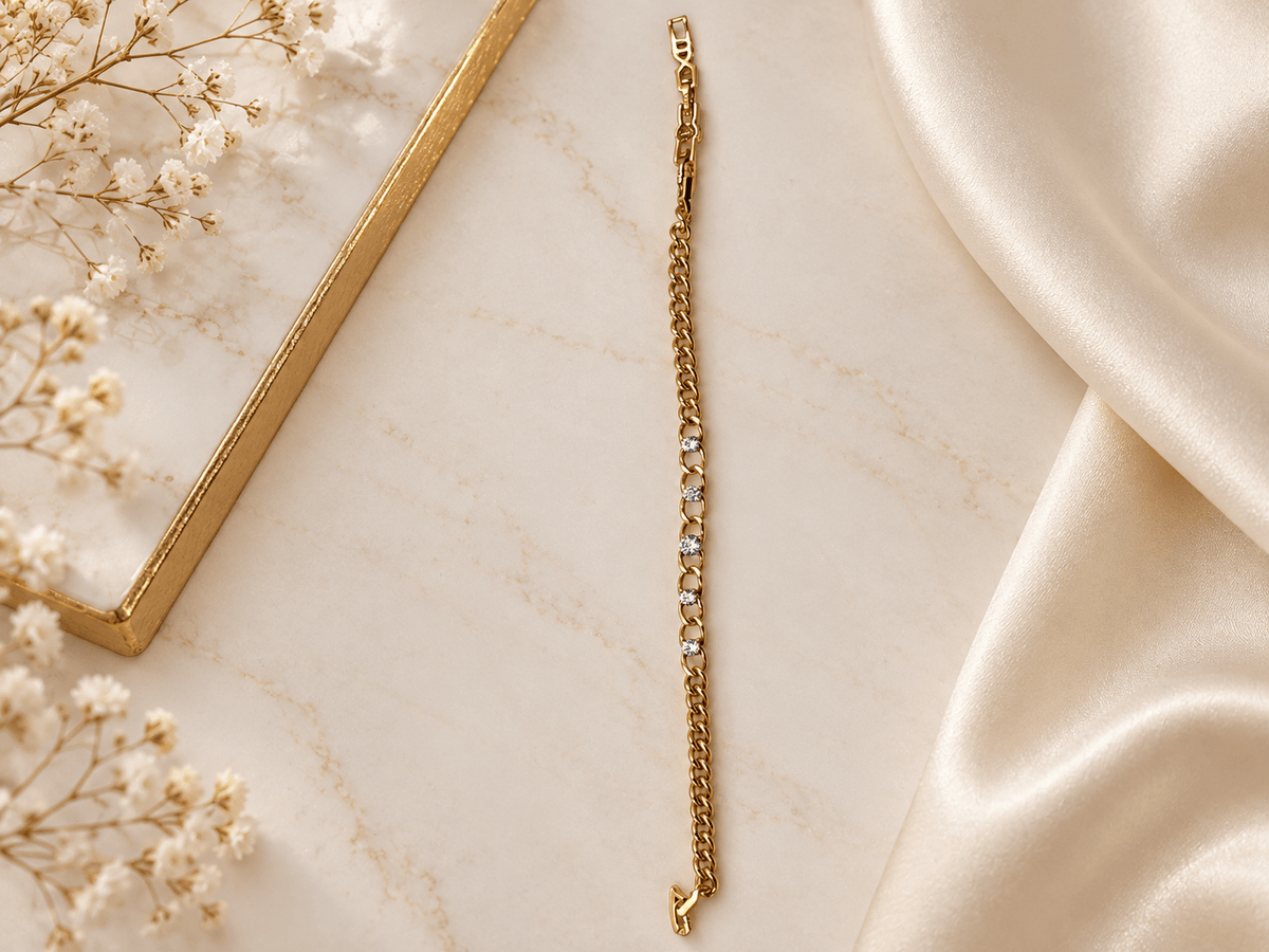 Bhavmayi golden bracelets with varied link designs and clear sparkling stone-like accents shown worn on the wrist