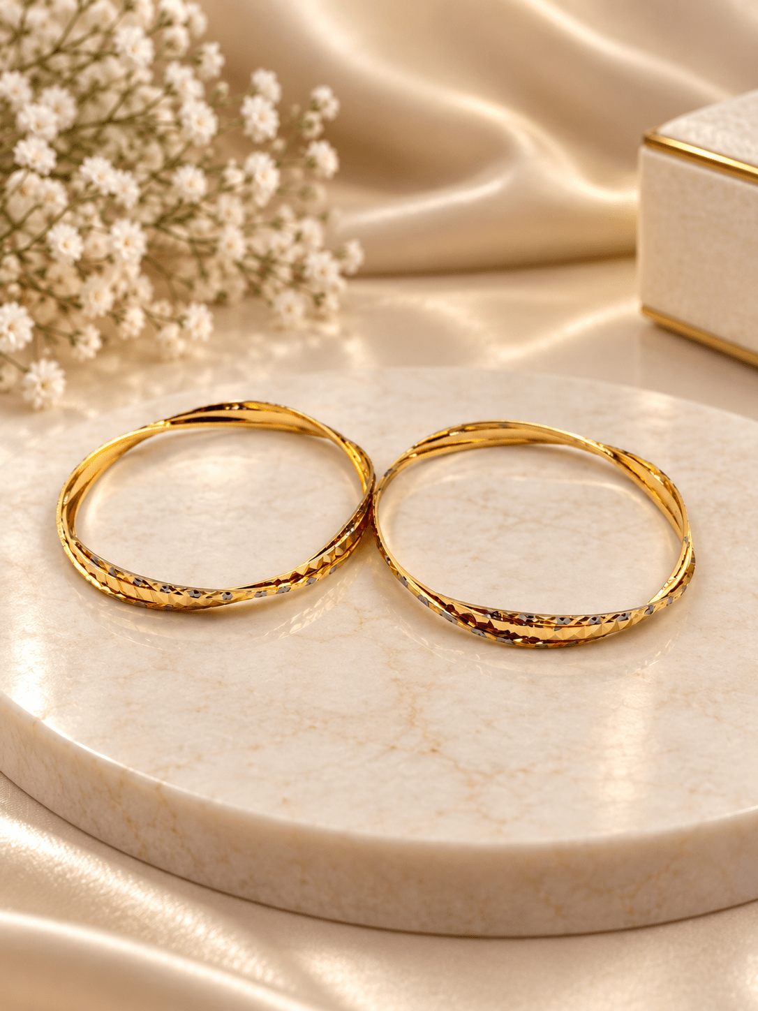 Bhavmayi gold-tone bangle pair with slim circular bands and faceted geometric textured detailing - bhavmayi