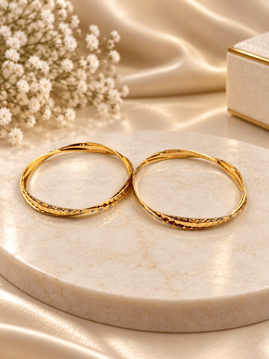 Bhavmayi gold-tone bangle pair with slim circular bands and faceted geometric textured detailing - bhavmayi