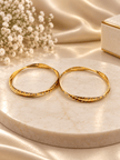 Bhavmayi gold-tone bangle pair with slim circular bands and faceted geometric textured detailing - bhavmayi