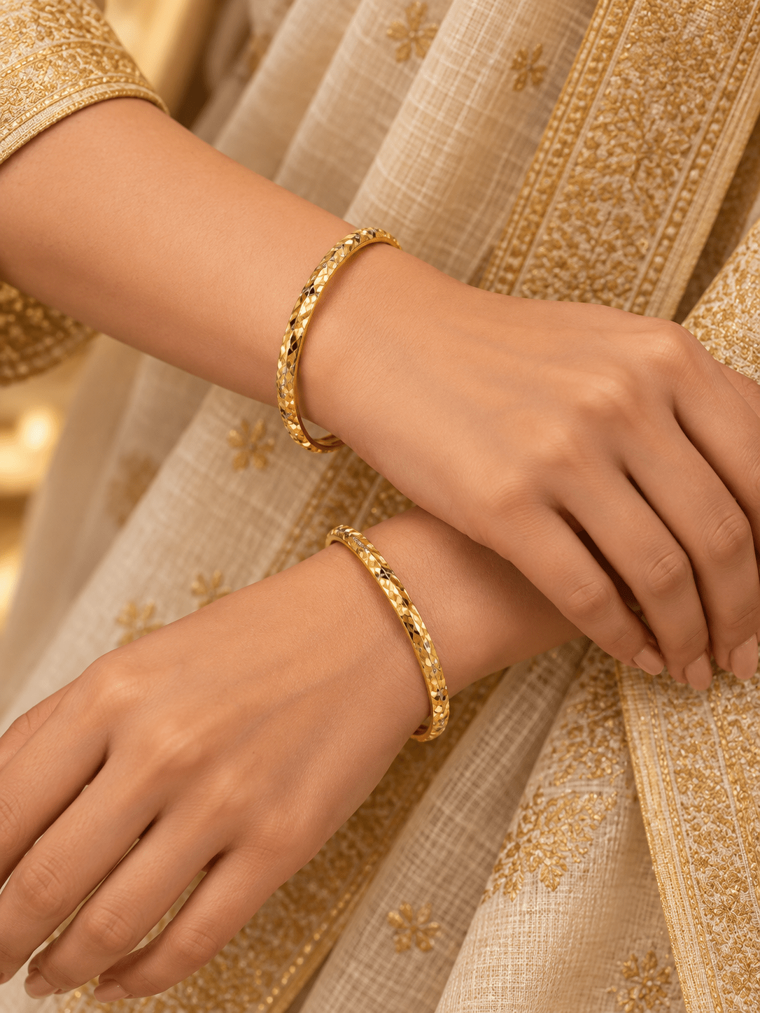 Bhavmayi gold-tone bangle pair with slim circular bands and faceted geometric textured detailing - bhavmayi