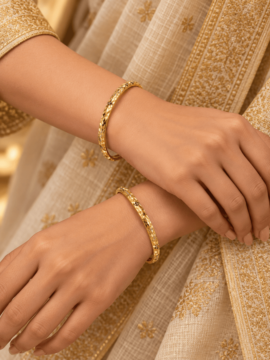Bhavmayi gold-tone bangle pair with slim circular bands and faceted geometric textured detailing - bhavmayi