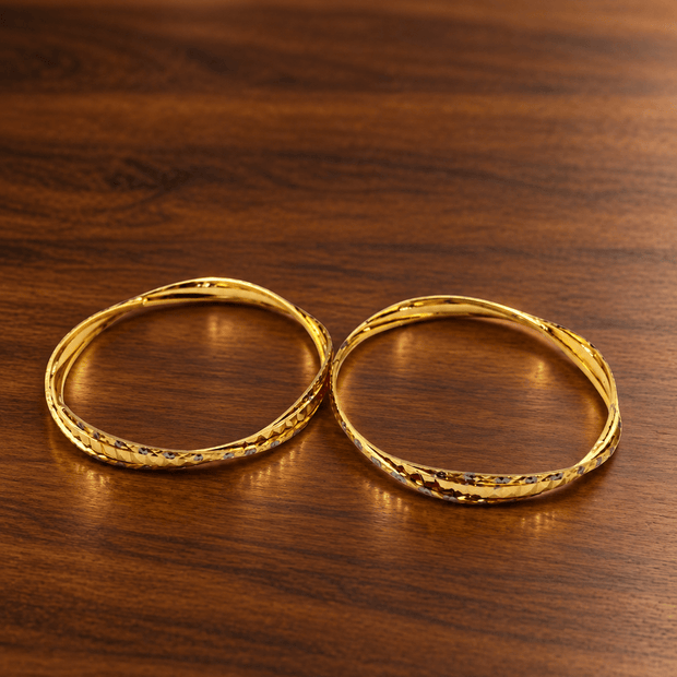 Bhavmayi gold-tone bangle pair with slim circular bands and faceted geometric textured detailing - bhavmayi