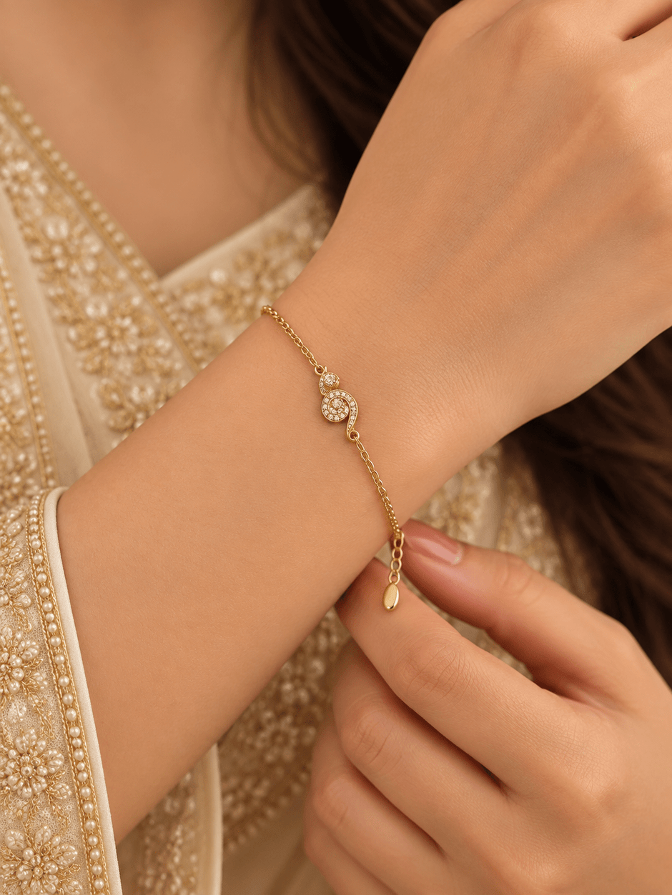 Bhavmayi gold-tone bracelet with a spiral motif covered in clear reflective accents and a delicate chain - bhavmayi