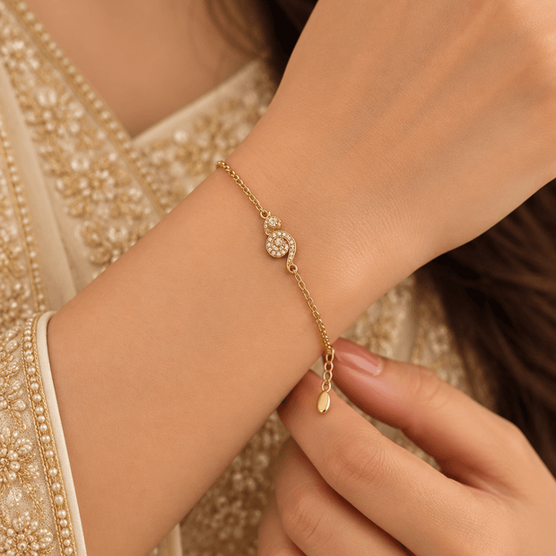 Bhavmayi gold-tone bracelet with a spiral motif covered in clear reflective accents and a delicate chain - bhavmayi
