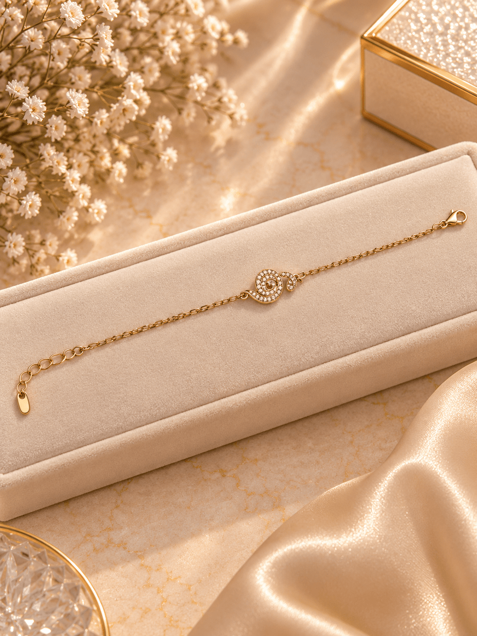 Bhavmayi gold-tone bracelet with a spiral motif covered in clear reflective accents and a delicate chain - bhavmayi