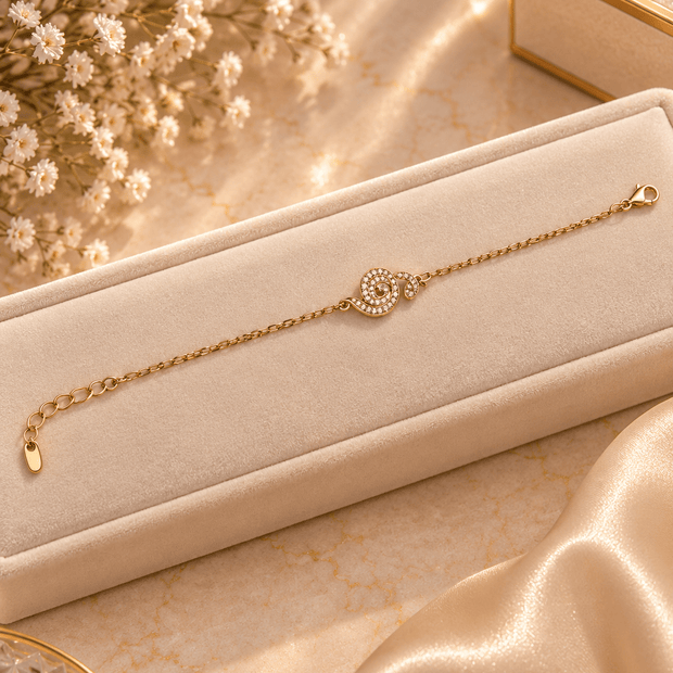Bhavmayi gold-tone bracelet with a spiral motif covered in clear reflective accents and a delicate chain - bhavmayi
