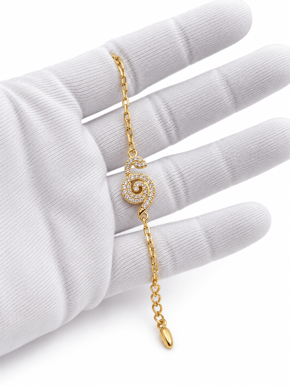 Bhavmayi gold-tone bracelet with a spiral motif covered in clear reflective accents and a delicate chain - bhavmayi