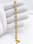 Golden bracelet with alternating oval and square clear sparkling accents and geometric link detailing